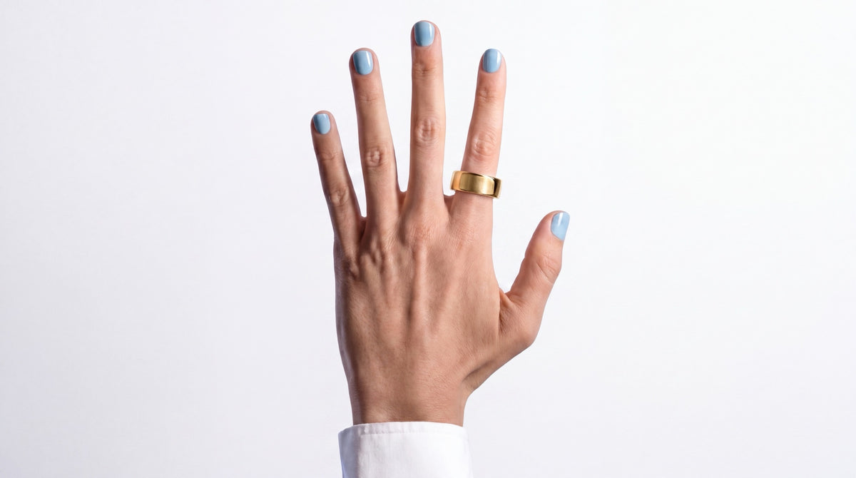 Hand met de SyncGear Smart Ring in goud, op een witte achtergrond